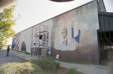 Lorenzo Green painting a patriotic mural on the side of Lambert's Cafe on Highway 59 in Foley, Alabama.