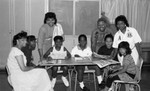 Thumbnail for Women posing with children who are reading, Los Angeles, 1989