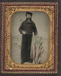 [Landsman Peter Depray in Union uniform at American flag-draped table in front of painted  backdrop showing Naval ship]