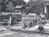 Police and firefighters on street after riot, Rochester, NY, 1964