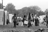 People carrying boxes and luggage through Resurrection City, an encampment of tents and shacks constructed on the National Mall in Washington, D.C., during the Poor People's Campaign.