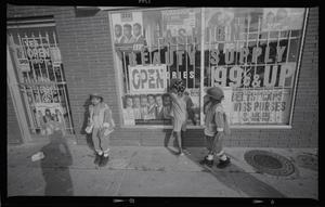 Three children in front of beauty supply store