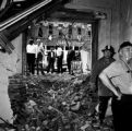 Fire fighter and another man standing in the rubble inside 16th Street Baptist Church in Birmingham, Alabama, after the building was bombed.