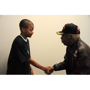 Thumbnail for Willis D. Saunders Jr. shakes hands with a young African American boy