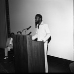 African American man speaking at a lectern, Los Angeles, 1972