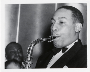 Johnny Hodges playing saxophone at the Savoy Ballroom : black-and-white photoprint.