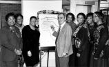 Roy Flores signing “Black Women are Beautiful Because. . .” poster