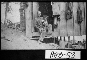 Photograph of man and young child in doorway of cabin, Clarkesville, Habersham County, Georgia, ca. 1907