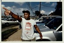 John Latimore directing pre-game traffic in a parking lot, November 10, 1991