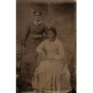 Two African American women in pleated skirts