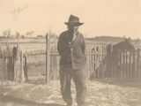 African American man standing in front of a picket fence in Crawford, Alabama.