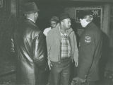 Policeman and group stand outside