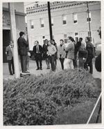 Mississippi State Sovereignty Commission photograph of Rims Barber speaking to Ed Williams, Frank Hudson, Bob Boyd and others gathered in front of the Greenville Post Office, Greenville, Mississippi, 1960s