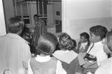 Children in the group "Buds of Promise" from Mt. Zion AME Zion Church in Montgomery, Alabama, singing to a young man on crutches at St. Jude Catholic Hospital in Montgomery, Alabama.