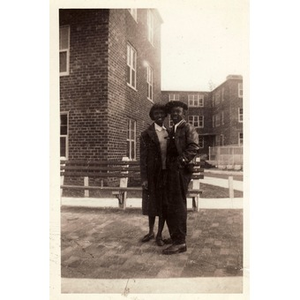 Two friends stand in front of the Lenox Street Projects