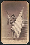 [Sergeant Joseph Atwood Hastings of Co. D, 118th New York Infantry Regiment in uniform with regimental flags]