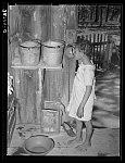 Daughter of Negro sharecropper drinking from hollow gourd. Near Marshall, Texas