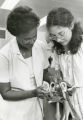 Michaelina Young demonstrates an anatomical model of the heart to one of her students