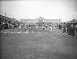 Sprinter Ralph Metcalfe wins NCAA race at Soldier Field, 1933