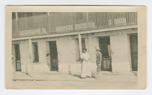 Photograph of a man and woman standing on a sidewalk