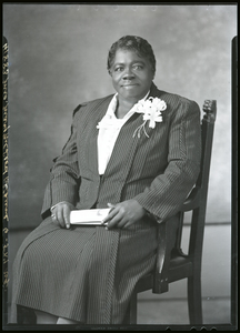 Mary McLeod Bethune sitting in chair, 3/4-length frontal, wearing striped suit with corsage : acetate film photonegative plus two enlarged prints