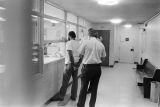 Sergeant Clifford Vasser and Lieutenant Doug Acker booking Anthony Ray Hinton on capital murder charges at the city jail in Bessemer, Alabama.