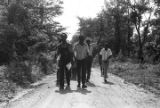 Edward Rudolph leading marchers down an unpaved road in Prattville, Alabama, during a demonstration sponsored by the Autauga County Improvement Association.