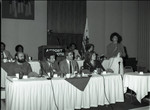 Participants on a panel listen to a speaker, Los Angeles, 1983