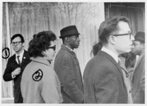 Mississippi State Sovereignty Commission photograph of Edward Lee Makamson, Jane Kyle (left to right) other unidentified demonstrators during an Anti-Vietnam War demonstration protesting Secretary of Defense Robert McNamara's visit to Jackson, Mississippi, 1967 February 24