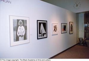 Photograph of the right side of an African-American gallery wall, featuring five art works