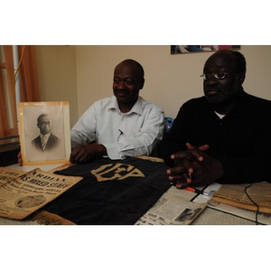 Stephen Hunter and David F. Hunter pose with a photograph of their father, Laymon Hunter