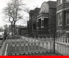 Street scene with brick two flats and fenced front yards