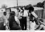 Representative Brock Adams campaigning with African-American constituents in Washington, 1968