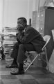 Arlam Carr sitting at a staff meeting at the Southern Courier office in the Frank Leu Building in Montgomery, Alabama.