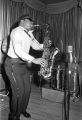 Bobby Moore playing the saxophone on stage at the Laicos Club in Montgomery, Alabama, during a performance by his group, Bobby Moore and the Rhythm Aces.