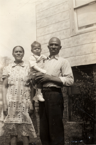 Lee Harris with his grandparents in front of their house