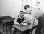 Willie Mays signing paperwork for the U.S. Army, where he was drafted to serve during the Korean War.