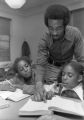 Man tutoring students at Saxon Homes