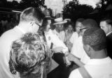 Richard Boone and Roosevelt Barnett speaking to a police officer during a civil rights demonstration in Montgomery, Alabama.