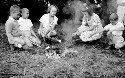 Unidentified group of children around fire