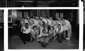 Prudhom Club entertainment group, man on floor holding guitar : panoramic acetate flim photonegative.