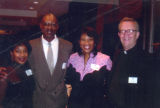 Robert A. Wild, S.J., poses with members of the Ethnic Alumni Association at a reception in his honor, 2001