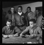 [Tuskegee airmen playing cards in the officers' club in the evening]