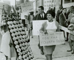 Demonstrators walk by Wallace campaign table