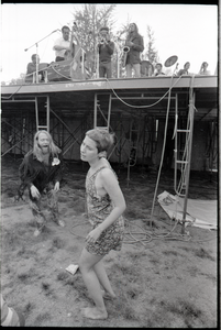 May Day concert and demonstrations: couple dancing below concert stage while Charles Mingus performs