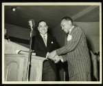 2 unidentified men shaking hands in an unidentified church, Chicago