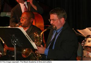 Two saxophonists playing on stage