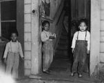 African American children standing in the doorway of a building, ca. 1952