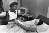 Carol Alston, a Marquette nursing student, practices on a mannequin, 1988-1992