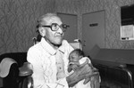 Woman holds baby, Los Angeles, 1983